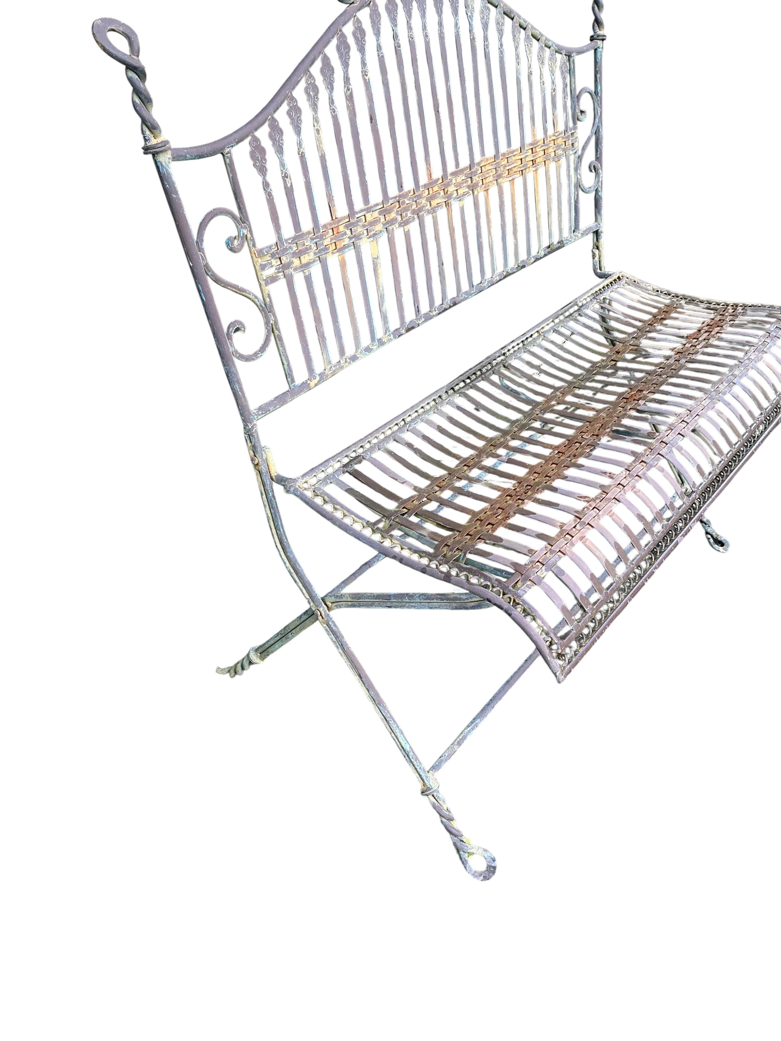 A wrought iron folding garden bench, width 99cm, depth 52cm, height 92cm
